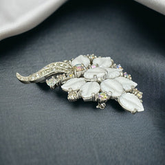 Vintage Jomaz floral spray brooch with molded milk glass leaves and aurora borealis rhinestones in silver tone setting, signed on reverse—1950s mid-century costume jewelry in excellent condition.