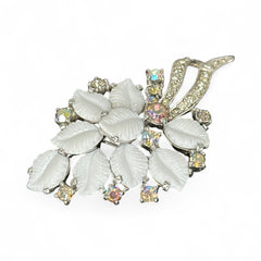 Vintage Jomaz floral spray brooch with molded milk glass leaves and aurora borealis rhinestones in silver tone setting, signed on reverse—1950s mid-century costume jewelry in excellent condition.