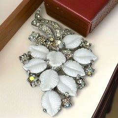 Vintage Jomaz floral spray brooch with molded milk glass leaves and aurora borealis rhinestones in silver tone setting, signed on reverse—1950s mid-century costume jewelry in excellent condition.