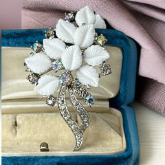 Vintage Jomaz floral spray brooch with molded milk glass leaves and aurora borealis rhinestones in silver tone setting, signed on reverse—1950s mid-century costume jewelry in excellent condition.