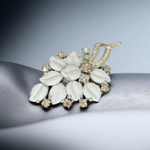 Vintage Jomaz floral spray brooch with molded milk glass leaves and aurora borealis rhinestones in silver tone setting, signed on reverse—1950s mid-century costume jewelry in excellent condition.