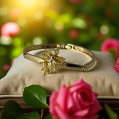 Vintage 1990s gold tone bracelet with curved links and a single jonquil marquise rhinestone flower centerpiece, elegant and gently worn.
