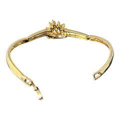 Vintage 1990s gold tone bracelet with curved links and a single jonquil marquise rhinestone flower centerpiece, elegant and gently worn.