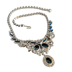 Vintage Juliana necklace with blue heliotrope oval stones and blue, green, and AB rhinestones in a silver‑tone setting.