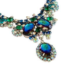 Vintage Juliana necklace with blue heliotrope oval stones and blue, green, and AB rhinestones in a silver‑tone setting.