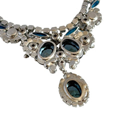 Vintage Juliana necklace with blue heliotrope oval stones and blue, green, and AB rhinestones in a silver‑tone setting.