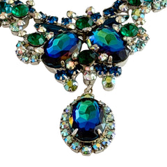 Vintage Juliana necklace with blue heliotrope oval stones and blue, green, and AB rhinestones in a silver‑tone setting.