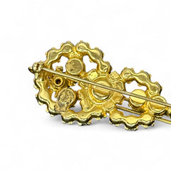 Vintage Juliana violin brooch in gold tone metal with green and peridot rhinestones, featuring layered construction and floral accents; verified design #3151 from the 1960s, shown from front and back.