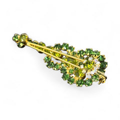 Vintage Juliana violin brooch in gold tone metal with green and peridot rhinestones, featuring layered construction and floral accents; verified design #3151 from the 1960s, shown from front and back.