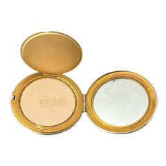 Vintage 1950s Kigu gold-tone powder compact with guilloché moiré lid, original puff, and mirror—collectible beauty accessory with timeless charm.
