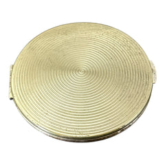 Vintage 1950s Kigu gold-tone powder compact with guilloché moiré lid, original puff, and mirror—collectible beauty accessory with timeless charm.
