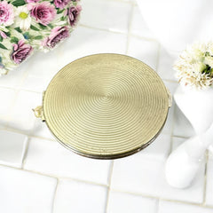 Vintage 1950s Kigu gold-tone powder compact with guilloché moiré lid, original puff, and mirror—collectible beauty accessory with timeless charm.
