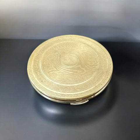 Vintage 1950s Kigu gold-tone powder compact with guilloché moiré lid, original puff, and mirror—collectible beauty accessory with timeless charm.

