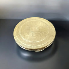 Vintage 1950s Kigu gold-tone powder compact with guilloché moiré lid, original puff, and mirror—collectible beauty accessory with timeless charm.
