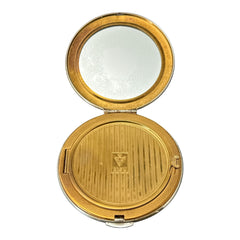 Vintage 1950s Kigu gold-tone powder compact with guilloché moiré lid, original puff, and mirror—collectible beauty accessory with timeless charm.
