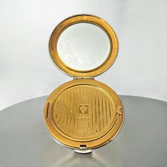 Vintage 1950s Kigu gold-tone powder compact with guilloché moiré lid, original puff, and mirror—collectible beauty accessory with timeless charm.
