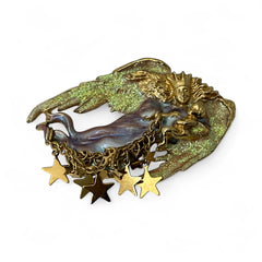 Vintage Kirk’s Folly guardian angel brooch with purple and cream enamel, iridescent sparkles, gold tone finish, signed on back, featuring angel holding baby with dangling star charms, excellent condition