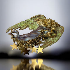 Vintage Kirk’s Folly guardian angel brooch with purple and cream enamel, iridescent sparkles, gold tone finish, signed on back, featuring angel holding baby with dangling star charms, excellent condition