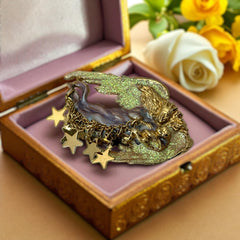 Vintage Kirk’s Folly guardian angel brooch with purple and cream enamel, iridescent sparkles, gold tone finish, signed on back, featuring angel holding baby with dangling star charms, excellent condition