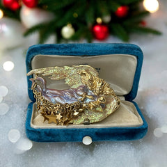 Vintage Kirk’s Folly guardian angel brooch with purple and cream enamel, iridescent sparkles, gold tone finish, signed on back, featuring angel holding baby with dangling star charms, excellent condition