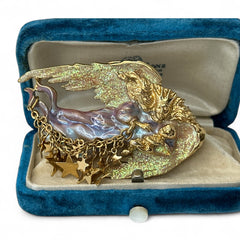 Vintage Kirk’s Folly guardian angel brooch with purple and cream enamel, iridescent sparkles, gold tone finish, signed on back, featuring angel holding baby with dangling star charms, excellent condition