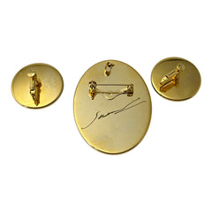 Hand-painted floral brooch and screw-back earrings set in lacquered wood with gold-tone trim, featuring red and pink flowers on a black background, signed by the artist.