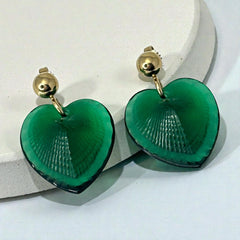 Vintage Lalique Telline earrings with translucent green satin glass hearts, ribbed textured fronts, polished backs etched with the Lalique signature, and gold plated posts, in excellent condition.