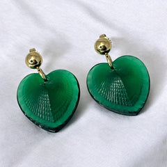 Vintage Lalique Telline earrings with translucent green satin glass hearts, ribbed textured fronts, polished backs etched with the Lalique signature, and gold plated posts, in excellent condition.