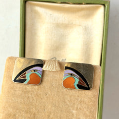 Vintage Laurel Burch “Tori Mon Bird of the Nile” square post earrings with orange, black, purple and green enamel bird motif on gold‑tone metal.