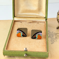 Vintage Laurel Burch “Tori Mon Bird of the Nile” square post earrings with orange, black, purple and green enamel bird motif on gold‑tone metal.