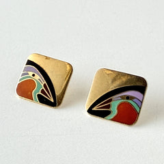 Vintage Laurel Burch “Tori Mon Bird of the Nile” square post earrings with orange, black, purple and green enamel bird motif on gold‑tone metal.
