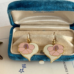 Vintage Laurel Burch Hibiscus Heart earrings with pink and white enamel flowers on gold‑tone heart dangles.