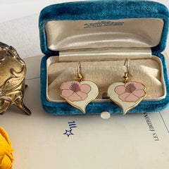 Vintage Laurel Burch Hibiscus Heart earrings with pink and white enamel flowers on gold‑tone heart dangles.