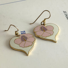 Vintage Laurel Burch Hibiscus Heart earrings with pink and white enamel flowers on gold‑tone heart dangles.