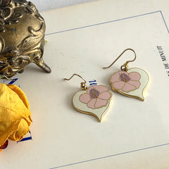 Vintage Laurel Burch Hibiscus Heart earrings with pink and white enamel flowers on gold‑tone heart dangles.
