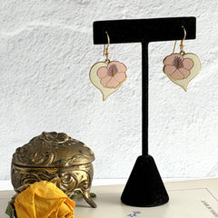 Vintage Laurel Burch Hibiscus Heart earrings with pink and white enamel flowers on gold‑tone heart dangles.