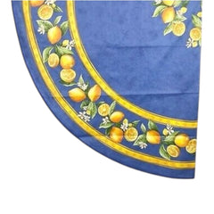 Provence coated cotton round tablecloth in blue with yellow lemon motif, green leaves, and lemon blossoms by Tissus Toselli.