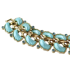 Vintage Leru light blue thermoset Lucite shell bracelet with gold‑tone links and blue rhinestones, signed Leru ©.
