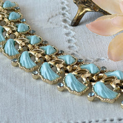 Vintage Leru light blue thermoset Lucite shell bracelet with gold‑tone links and blue rhinestones, signed Leru ©.