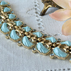 Vintage Leru light blue thermoset Lucite shell bracelet with gold‑tone links and blue rhinestones, signed Leru ©.