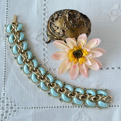 Vintage Leru light blue thermoset Lucite shell bracelet with gold‑tone links and blue rhinestones, signed Leru ©.