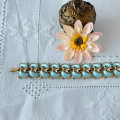 Vintage Leru light blue thermoset Lucite shell bracelet with gold‑tone links and blue rhinestones, signed Leru ©.