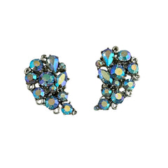 Vintage Lisner silver tone clip-on earrings with blue Aurora Borealis rhinestones in a leaf-shaped climber design, shown in various arrangements.