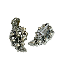 Vintage Lisner silver tone clip-on earrings with blue Aurora Borealis rhinestones in a leaf-shaped climber design, shown in various arrangements.