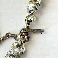 Vintage Lisner aurora‑borealis topaz and black enamel gold‑tone floral necklace with adjustable hook clasp and hangtag, shown on botanical background to highlight sparkle and craftsmanship.