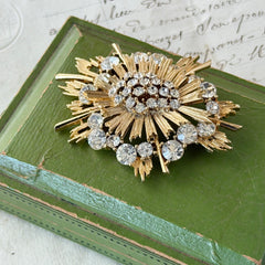 Vintage Lisner gold‑tone sunburst brooch with clear rhinestones, 1960s, signed Lisner ©, excellent condition.