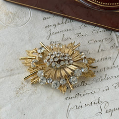 Vintage Lisner gold‑tone sunburst brooch with clear rhinestones, 1960s, signed Lisner ©, excellent condition.