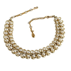 Vintage Lisner necklace with faux pearls and gold‑tone links, shown from various angles to display its mid‑century design, adjustable length, and signed clasp.