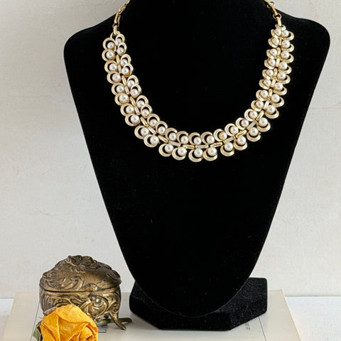 Vintage Lisner necklace with faux pearls and gold‑tone links, shown from various angles to display its mid‑century design, adjustable length, and signed clasp.