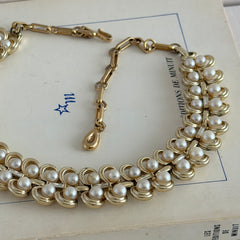 Vintage Lisner necklace with faux pearls and gold‑tone links, shown from various angles to display its mid‑century design, adjustable length, and signed clasp.